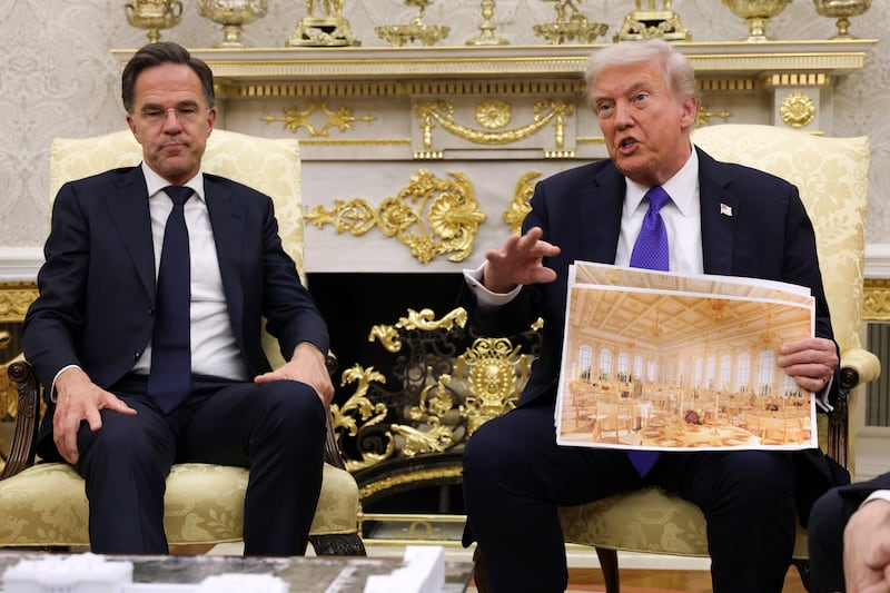 WASHINGTON, DC - OCTOBER 22: U.S. President Donald Trump displays a rendering of his proposed $250 million White House ballroom as he meets with NATO Secretary General Mark Rutte (L) in the Oval Office of the White House on October 22, 2025 in Washington, DC. Less than a week after hosting Ukrainian President Volodymyr Zelensky, Trump is meeting with Rutte to discuss the war in Ukraine. (Photo by Alex Wong/Getty Images)
