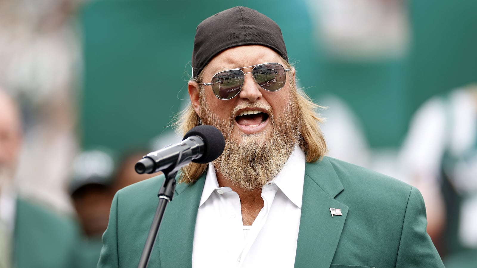 EAST RUTHERFORD, NEW JERSEY - SEPTEMBER 25: Former New York Jets player Nick Mangold speaks as he is inducted into the Jets Ring of Honor during halftime of the game against the Cincinnati Bengals at MetLife Stadium on September 25, 2022 in East Rutherford, New Jersey. (Photo by Sarah Stier/Getty Images)