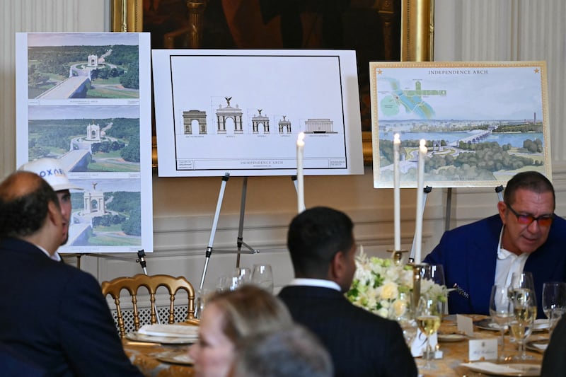 Pictures with various designs for a proposed "Independence Arch" are seen during a dinner hosted by the US president with ballroom donors in the East Room of the White House in Washington, DC on October 15, 2025. US President Donald Trump, who is remodeling the White House to his tastes, will build a massive ballroom for hosting official receptions, one of the largest projects at the US executive mansion in over a century. (Photo by ANDREW CABALLERO-REYNOLDS / AFP) (Photo by ANDREW CABALLERO-REYNOLDS/AFP via Getty Images)