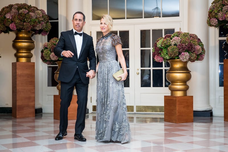 Jerry Seinfeld in a tuxedo with his wife in a ballgown