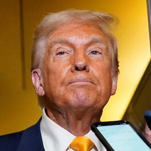 U.S. President Donald Trump looks on as he addresses the media on board Air Force One on the way to West Palm Beach, Florida, U.S., April 13, 2025. REUTERS/Nathan Howard