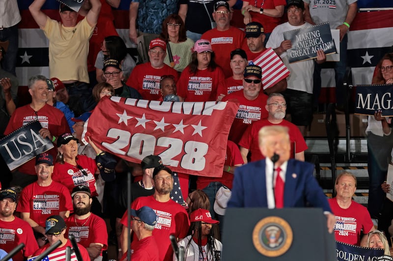 Auto Workers for Trump hold up a Trump 2028 banner during a rally marking President Trump's 100th day in office in April.