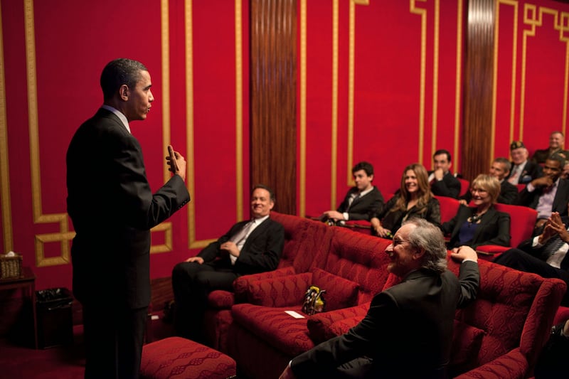 President Barack Obama delivers remarks before a screening of “The Pacific” in the Family Theater of the White House in 2010. Sitting front row is Tom Hanks, left, and Steven Spielberg, right.