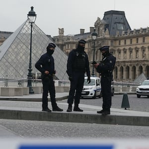 French police officers patrol in front of the Louvre Museum in Paris after it was robbed on October 19, 2025.