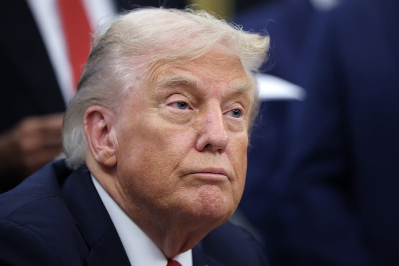 WASHINGTON, DC - SEPTEMBER 30: U.S. President Donald Trump (L) answers questions while childhood cancer survivors and their families gather in the Oval Office at the White House on September 30, 2025 in Washington, DC. According to Trump, the executive order he was signing will accelerate pediatric cancer research, including by harnessing the power of artificial intelligence. (Photo by Win McNamee/Getty Images)