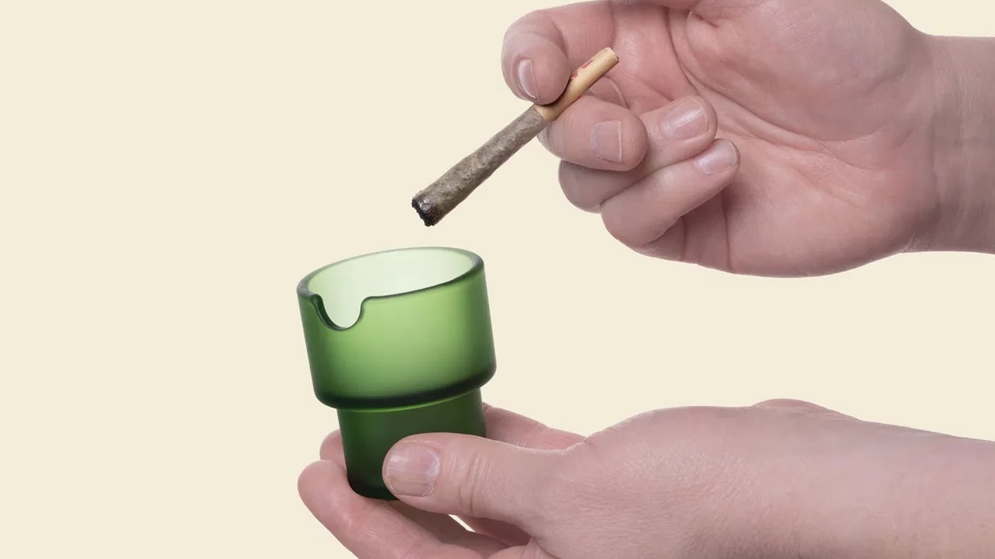Hands holding a marijuana cigarette over a NWTN Home Flower Pot Ashtray