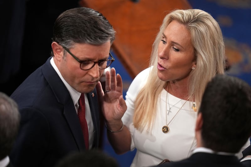 Speaker of the House Mike Johnson (R-LA) (L) talks to Rep. Marjorie Tayler Greene (R-GA) as they arrive for the first day of the 119th Congress in the House Chamber of the U.S. Capitol Building on January 03, 2025 in Washington, DC.