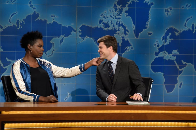 SATURDAY NIGHT LIVE -- "Emma Stone" Episode 1712 -- Pictured: (l-r) Leslie Jones and Colin Jost during Weekend Update on December 3, 2016 -- (Photo by: Will Heath/NBCU Photo Bank/NBCUniversal via Getty Images via Getty Images)