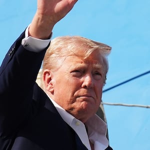 LOSSIEMOUTH, SCOTLAND - JULY 29: U.S. President Donald Trump waves as he boards Air Force One at RAF Lossiemouth, on July 29, 2025 in Lossiemouth, Scotland. President Trump visited Scotland on a trip that was part-vacation, part-work, as he stayed at his Trump Turnberry golf course, followed by the Trump International Golf Links in Aberdeenshire, between July 25 to 29. (Photo by Andrew Harnik/Getty Images)